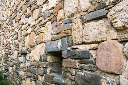 Background of the masonry of an ancient temple. Place of religious ceremonies. An ancient stone wall.