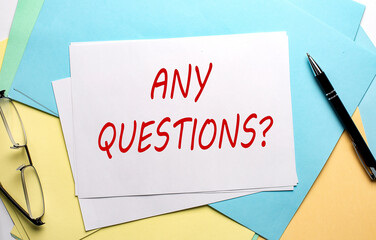 ANY QUESTIONS text on paper on the colorful paper background