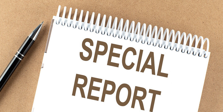 SPECIAL REPORT ext on a notepad with pen, business