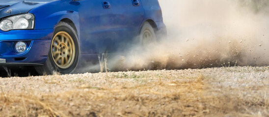 Rally racing car on dirt track.