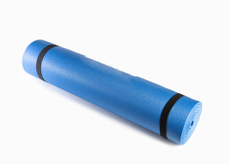 Blue mat for yoga and fitness classes on a white background, close-up.