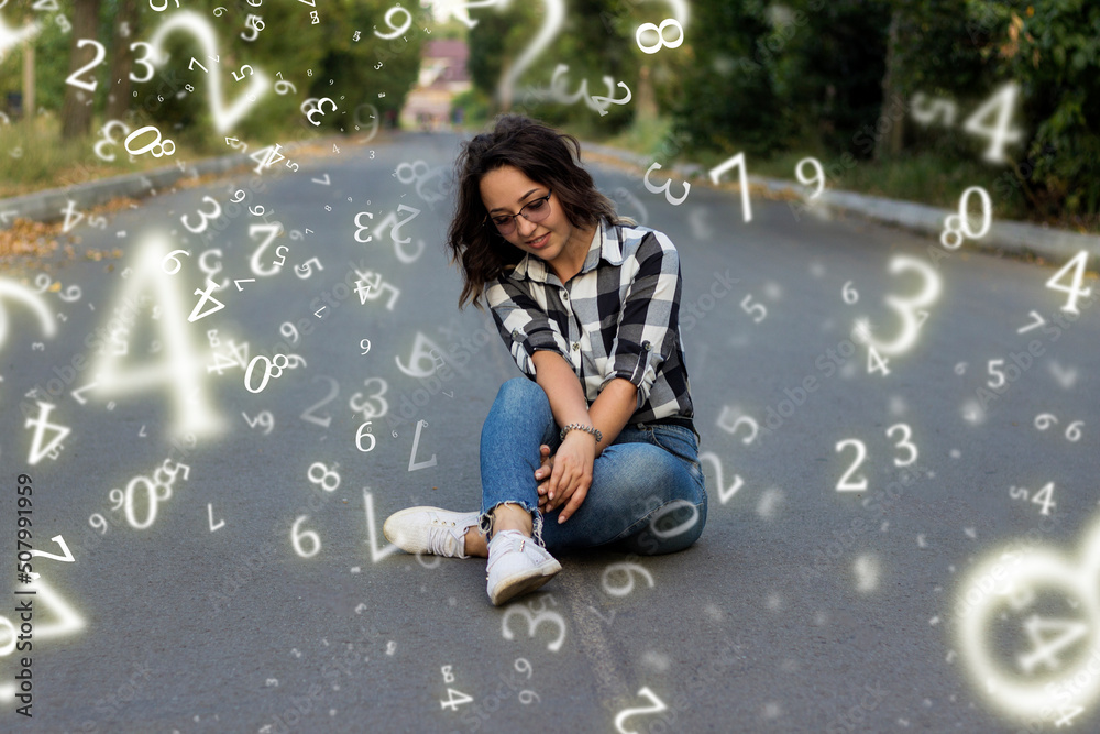 Wall mural numerology, a girl sits on an asphalt road surrounded by numbers