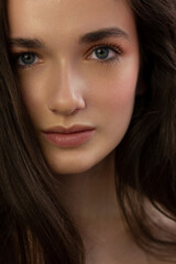 Obraz premium Close-up portrait of a beauty woman with full lips, straight hair and perfectly clean skin. Daytime makeup, styling and soft care. Skin care in the spa salon or cosmetology, smooth eyebrows