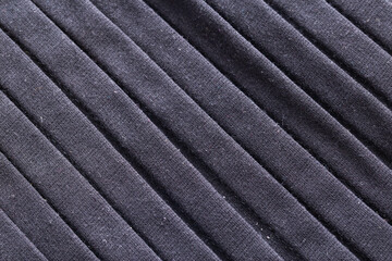 Black modern folded fabric, background. Macro, fashion