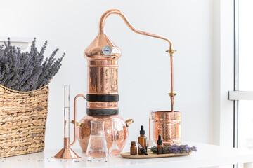 Distillation of lavender essential oil. Copper alambic in a Scandinavian interior. Chemical...