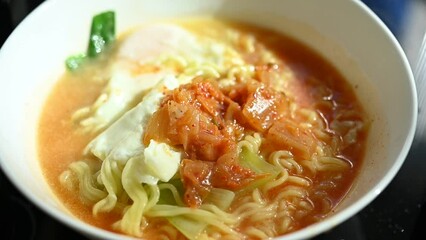 slow motion scene, spicy instant noodles easy food cooking with egg and kimchi