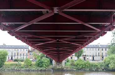 Underside of Steel Suspension Bridge Spanning River 