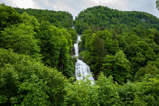 Giessbach waterfall in the Swiss Alps, Canton of Bern. Sunny summer day, green nature, no people