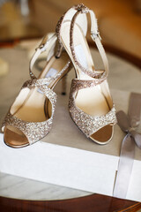 Bridal shoes embellished with shiny stones on the table