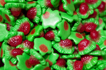 Candy sweets jelly. Close up view of delicious sweet candies in form of raspberry. Fruit jelly in shop window. Sweets for Easter, Halloween. Unhealthy or organic food. Selective focus. Top view 