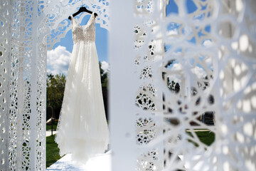 Wedding dress hanging in the ceremony area