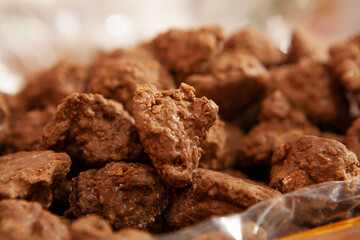 Candy chocolate sweets. Close up view of delicious chocolate candies with nuts. Chocolate candys in shop window. Sweets for Easter, Halloween. Unhealthy or organic food. Selective focus 
