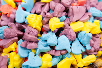 Candy sweets jelly. Close up view of delicious sweet candies in form of unicorns heads. Fruit jelly in shop window. Sweets for Easter, Halloween. Unhealthy or organic food. Selective focus. Top view 