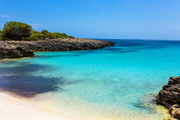 Fototapeta na wymiar Cala Es Talaier in Menorca, Balearic Island, Spain - Beautiful turquoise sea water beach in sunny day