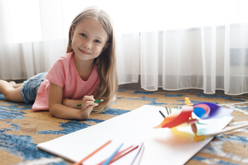 cute little girl drawing at home