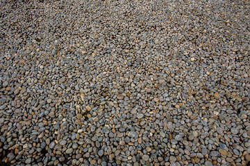 Colorful small round stones in a large stone courtyard