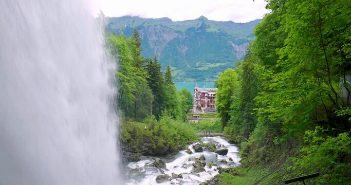 Giessbach waterfalls in the bernese Alps, Interlaken region, Switzerland. Cloudy summer day, green vegetation, real time, no people, Grandhotel Giessbach visible in the background. Giessbachfälle
