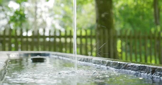 Clean And Clear Water Flowing From A Public Wooden Drinking Water Fountain In A Forest In Switzerland, Europe. Real Time Close Up Shot, No People