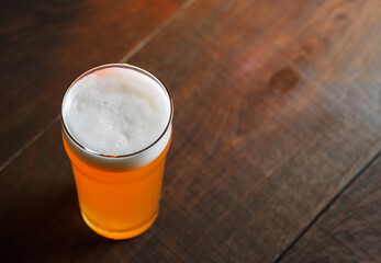 glass of craft beer indian pale ale on a wooden table, copy space