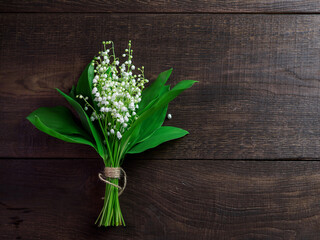 Bouquet of lilies of the valley on a wooden table