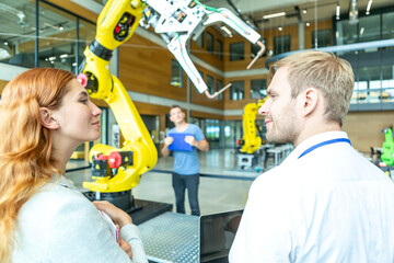 Engineers inspect industrial robot