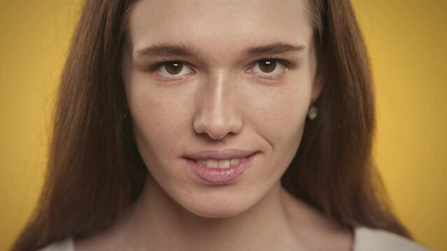 Extreme close up of a smiling caucasian young adult woman