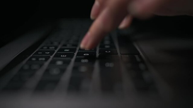 Macro close-up of female hands busy working on laptop or computer keyboard for send emails and surf on a web browser.