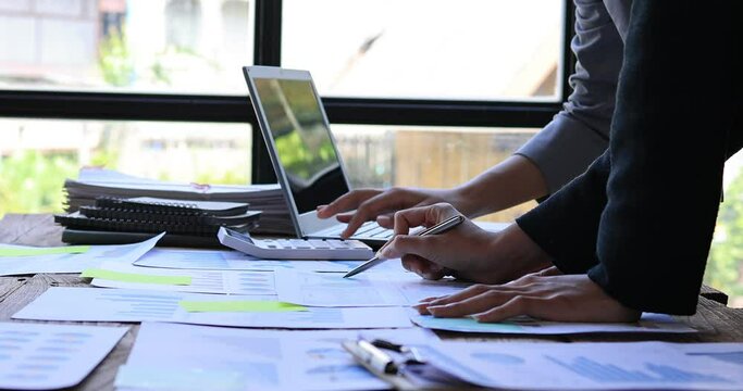 4k video footage of a group of young Business people discuss investment project working on Statistical analysis and accounting of annual financial data of enterprises