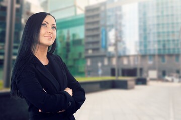 Businesswoman standing on the street of a city.