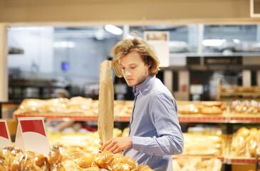 Man choosing bread from a supermarket.
