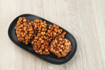 Ampyang Kacang or Gula Kacang, Indonesian traditional snack, made from peanuts and brown sugar. The taste of this snack is very sweet.
