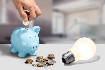 A light bulb on a pile of coins Energy saving and accounting concepts in the office concept.