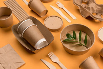 Eco-friendly paper tableware - kraft paper food packaging on orange background. Street food paper...