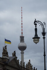 Fototapeta na wymiar Berliner TV-tower with lantern and Ukrainian flag, vertical 