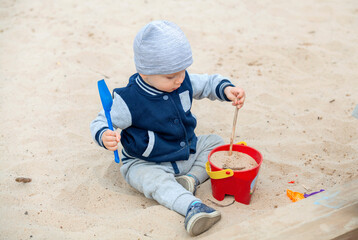 Adorable little boy on playground on a sunny day.
