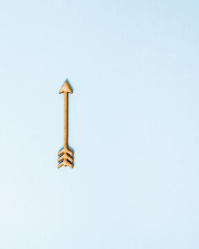 Rising arrow on pastel blue background. Minimal concept of inflation or rising prices. Success in business idea with copy space. Launched to achieve the goal.