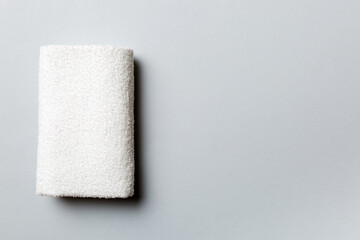 Top view of white towels with copy space on colored background