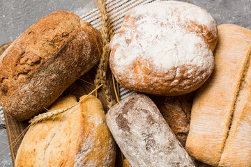 Homemade natural breads. Different kinds of fresh bread as background, perspective view with copy space