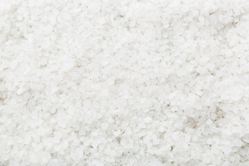 Background from white sea salt. Coarse rock salt texture witth copy space