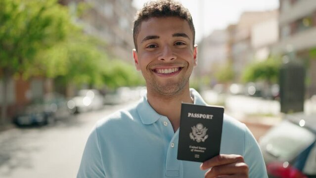 African american man smiling confident pointing with finger to united states passport at street