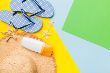Summer vacation concept flat lay. straw hat beach accessories and flip flop top view. Space for...
