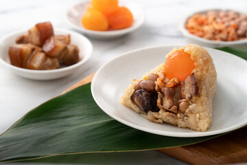 Zongzi, rice dumpling for Dragon Boat Festival on bright marble table background with ingredient.
