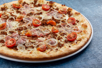 pizza with meat and cherry tomato
