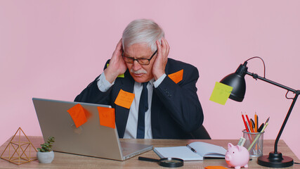 Tired exhausted fatigue senior business man office employee manager sits in office table with...