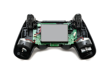 Fototapeta premium Controle de videogame aberto, com seu interior exposto, mostrando placa, circuitos e bateria. 