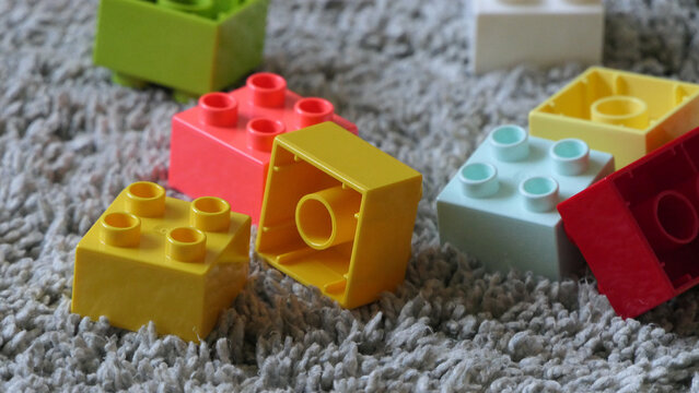 Mix of Colourful Pieces of Bricks sitting on mat indoors