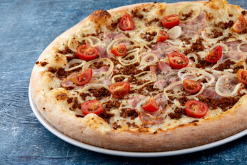 pizza with meat and cherry tomato