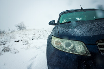 The four-wheel drive car of the modern SUV remains on the side of the winter road.
