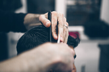 Male client getting haircut by hairdresser