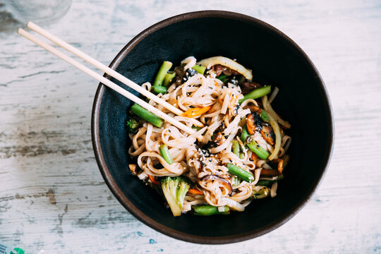 View osf asian noodles udon with pork close-up in a bowl on the table. Flat view.